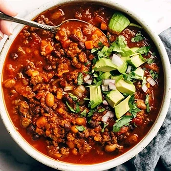 A top view of cooked chili on a white bowl