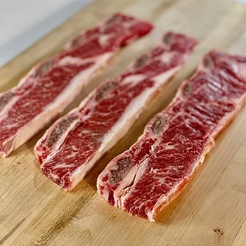 A raw flanken-style ribs on a wooden board