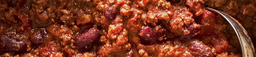 A close up shot of chili that was stored in the fridge