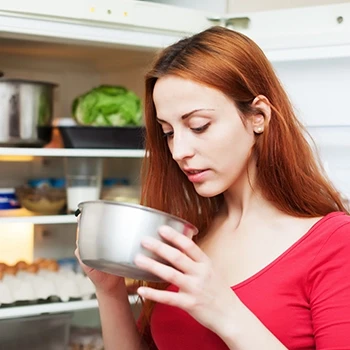 A woman checking if chili has gone bad