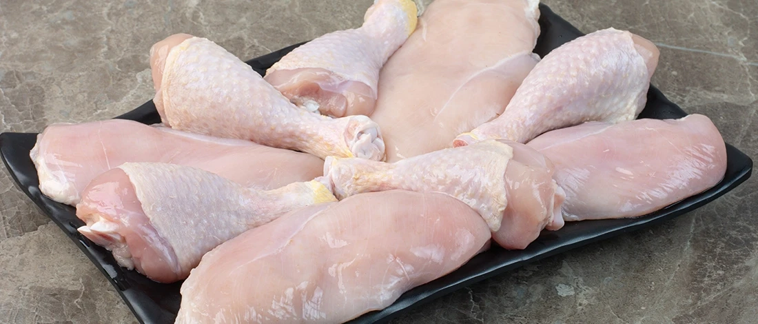 A raw chicken cuts of meat ready to be stored in the fridge