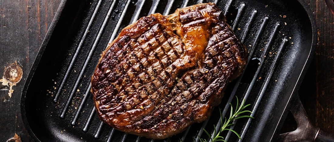 A top view of a steak cooked on a griddle pan