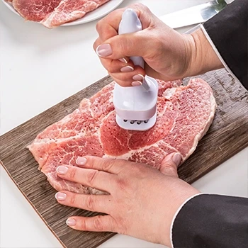 A person pounding and tenderizing the steak