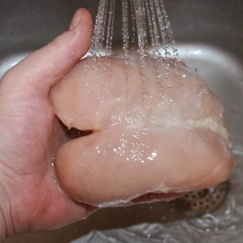 Rinsing chicken breasts with cold water
