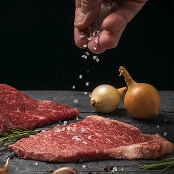 Putting salt on a steak to tenderize it