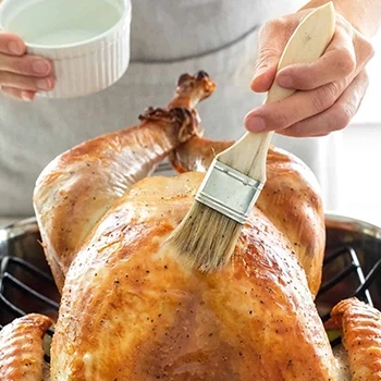 Brushing melted butter on a turkey