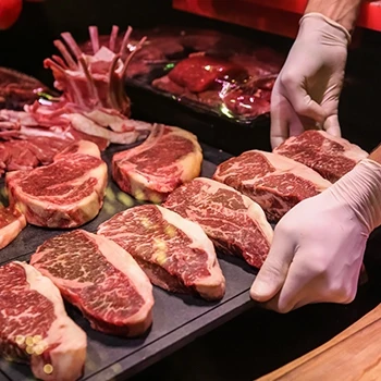 A butcher arranging the primal cuts of beef