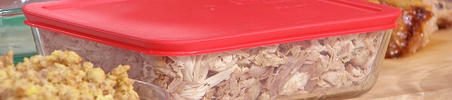 Sliced leftover turkey placed inside a large food container