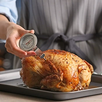Using a meat thermometer on a cooked turkey