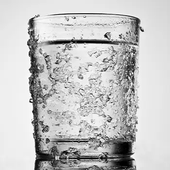 a glass of water being prepared for checking the meat temperature