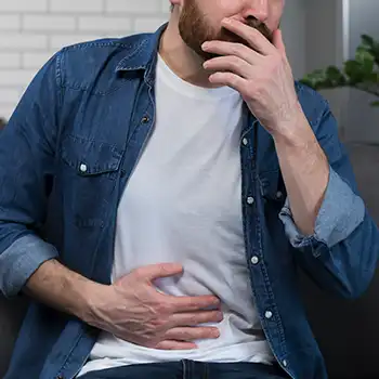 a man having stomach cramps because of ground beef turning gray