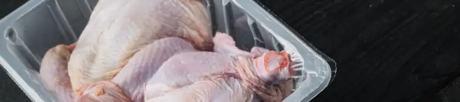 raw chickens sitting out in a transparent container