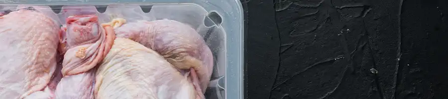 raw chicken in a plastic-sealed container that is refreeze