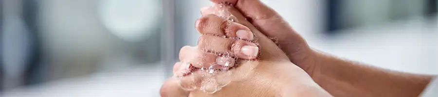 a person washing its hands with soup