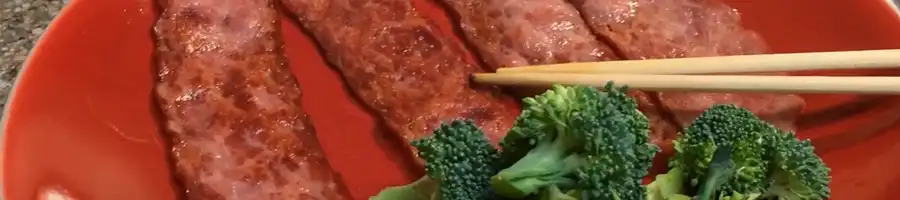 a photo of turkey bacon and broccoli in a plate