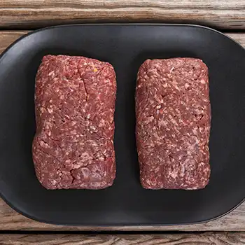 ground pork on a black plate