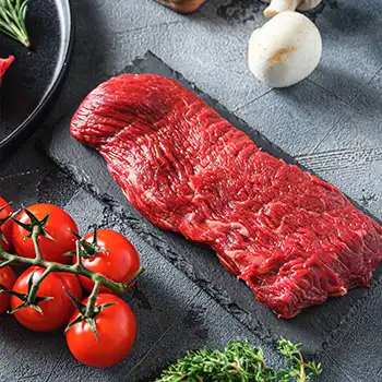 a bottom sirloin steak on a black slate