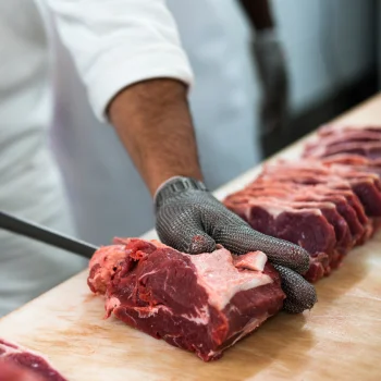 Chef cutting bone off meat