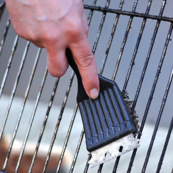Man cleaning a grill