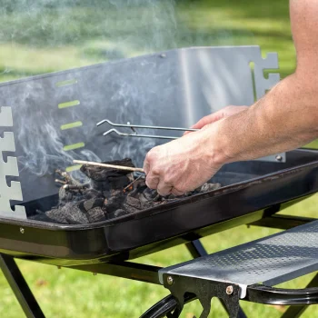 opening the lid of the Charcoal grill