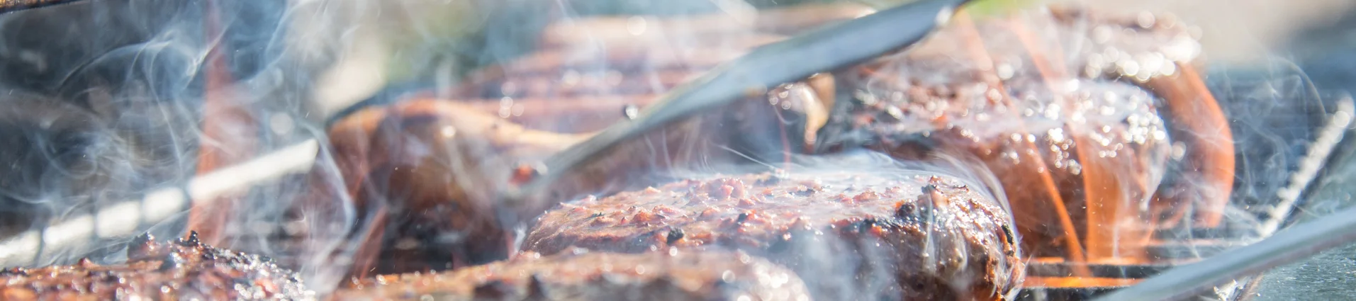 Steak smoking on the grill