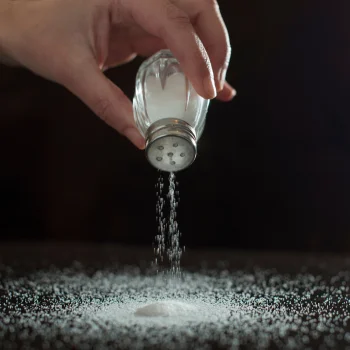 Person pouring salt