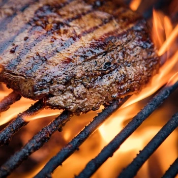 A steak being cooked on the grill