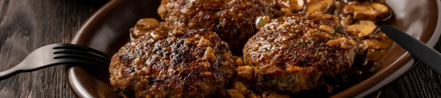 A close up shot of Salisbury Steak with Mushroom Gravy