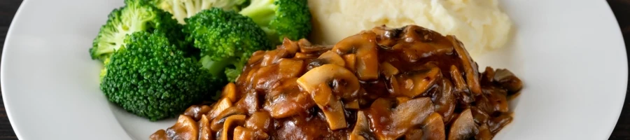 A delicious Salisbury steak on a white plate