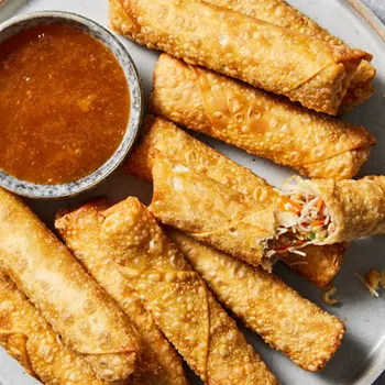 egg rolls on plate with dipping sauce