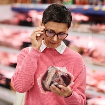 A woman making sure of the good quality meats