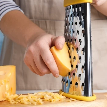 A woman grating a cheese