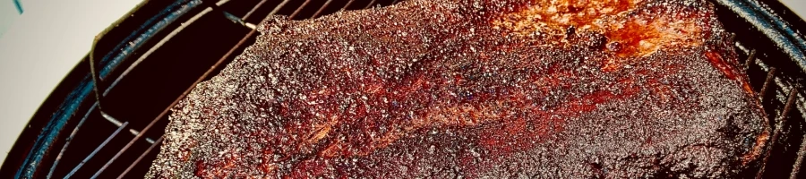 A close up shot of a brisket in a smoker