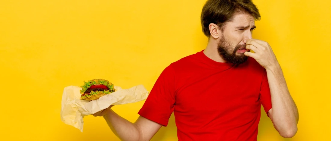 A man holding a smelly spoiled food