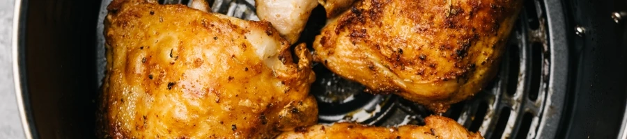 Chicken being cooked in an air fryer