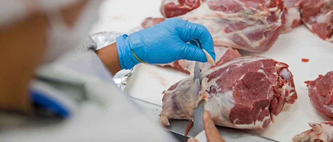 A person cutting the meat