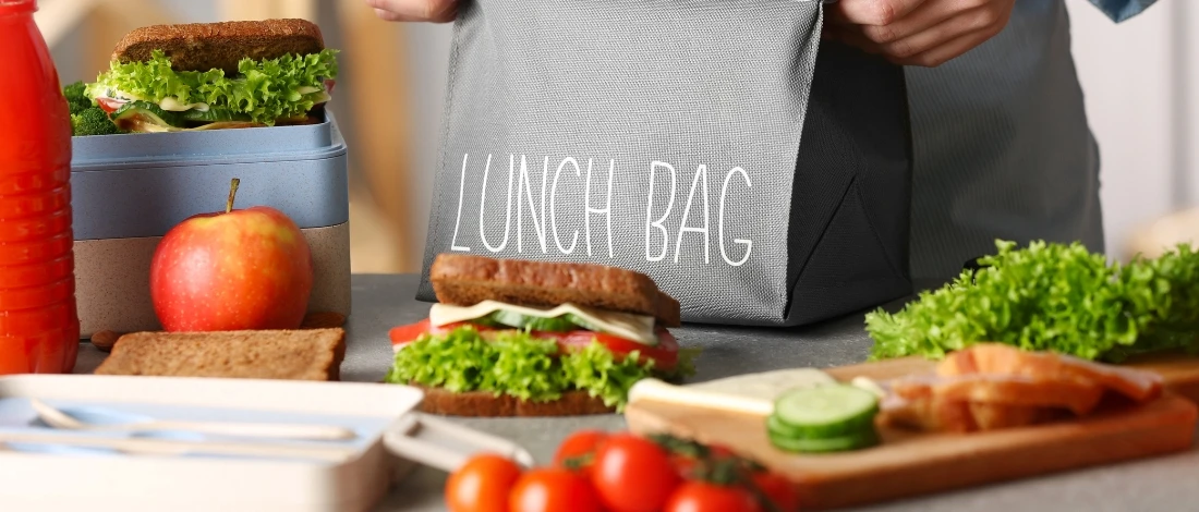 A person packing nutritious food for school