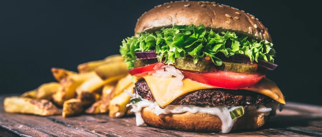 A delicious burger with fries on the side