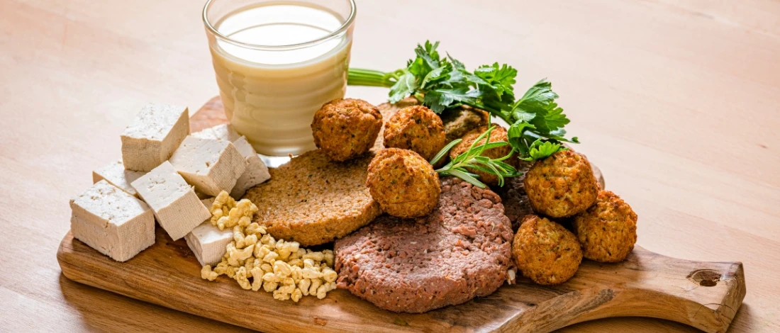 A plant based meat with its ingredients on a cutting board