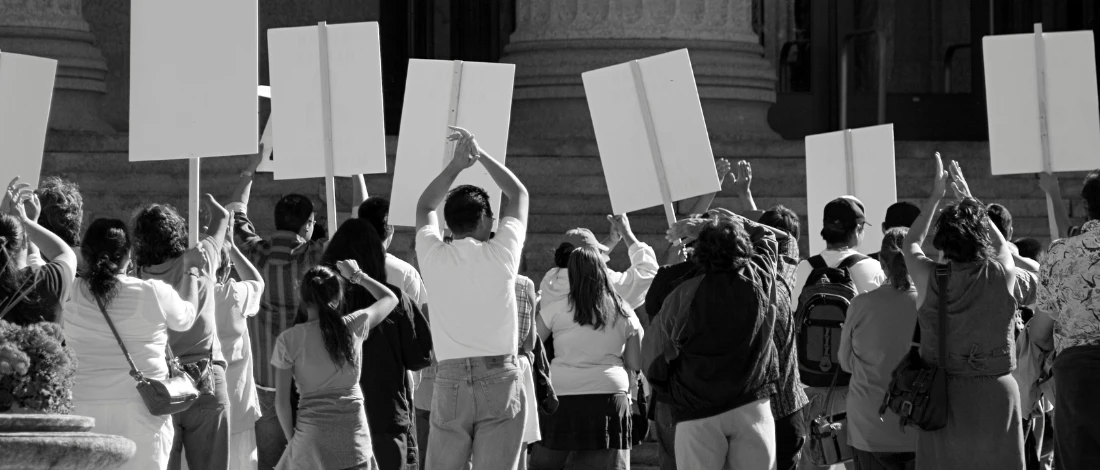 A black and white photo of people rallying
