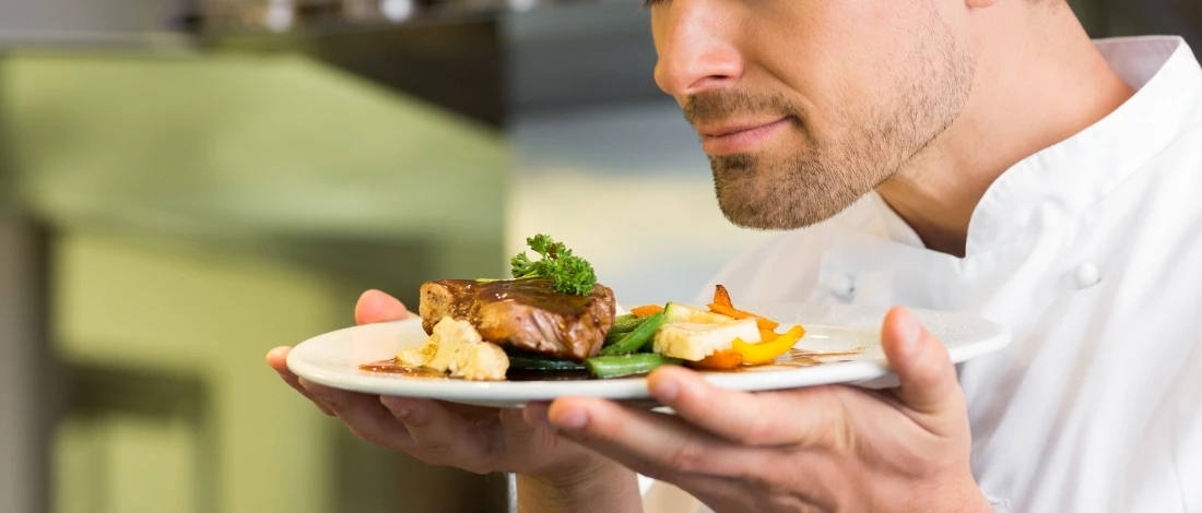 A person sniffing the meat