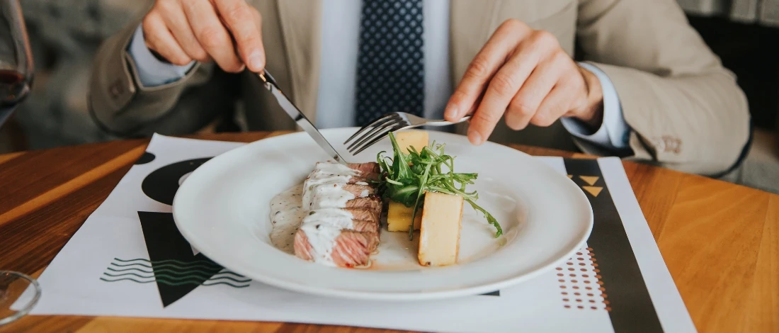 A man eating a steak in a steakhouse