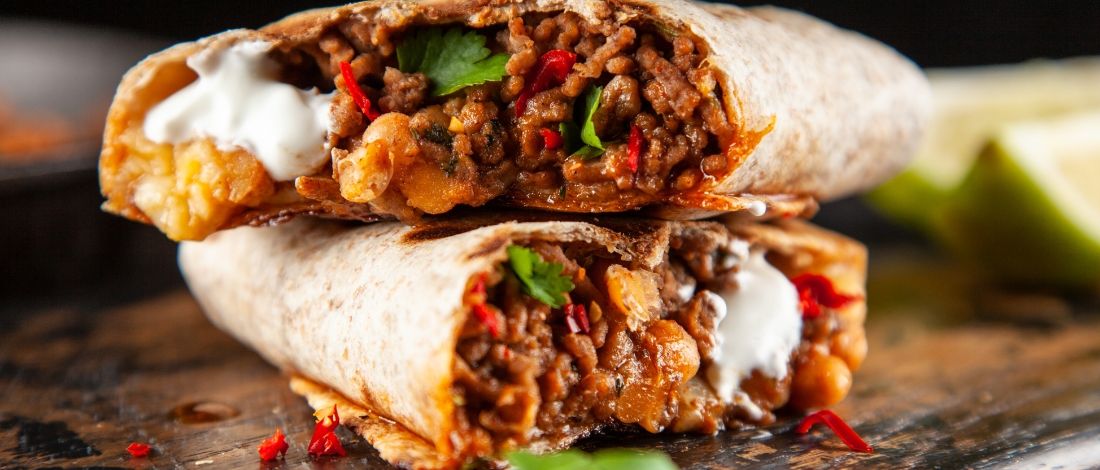 A beef burrito cut in half