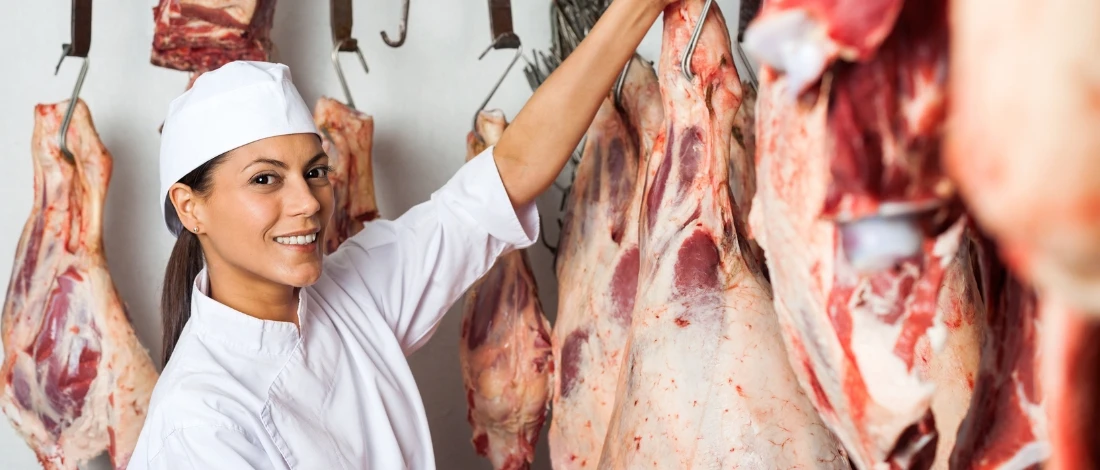 A woman holding the hanging meat