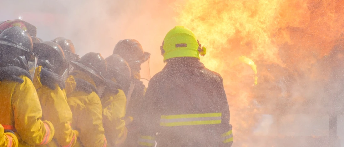 The fire fighter was extinguishing the fire