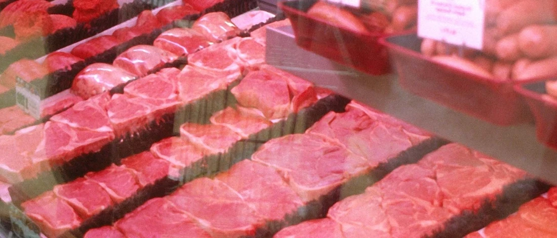 A close up shot of meat in the chiller