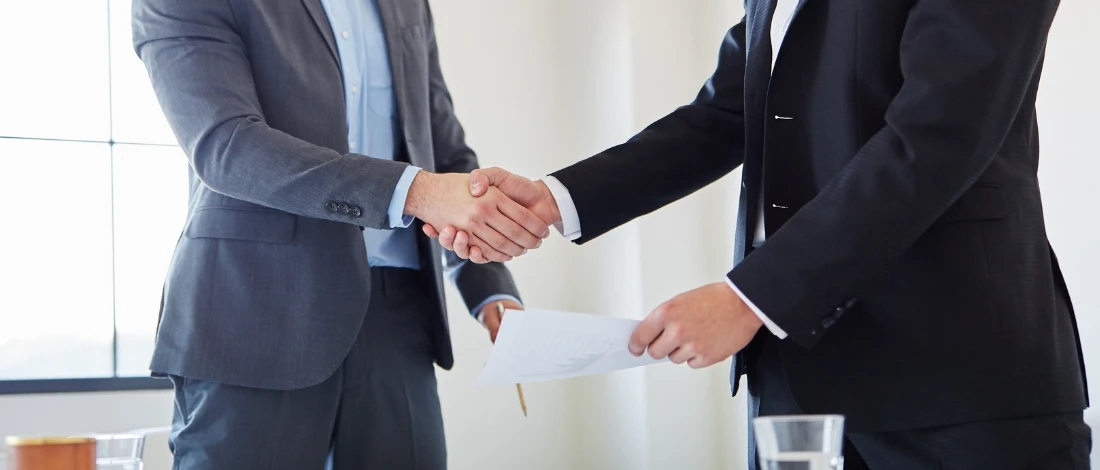 The two people are doing handshake