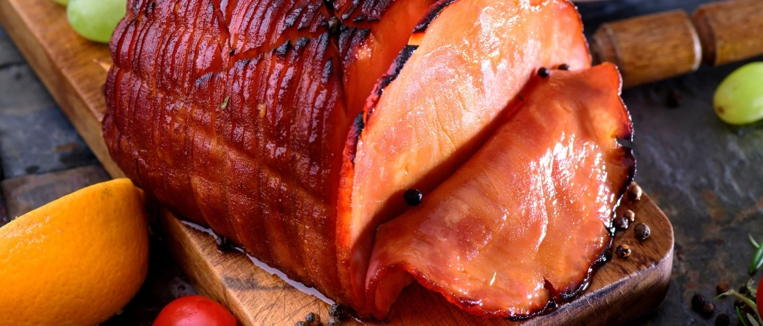 A tasty sliced ham on a cutting board