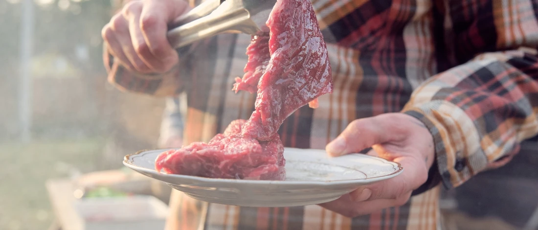 A farmer curing a meat