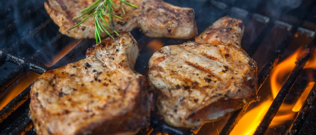 A steak grilling on fire